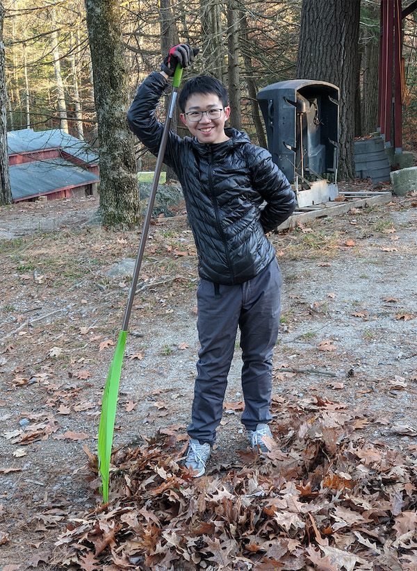 Cleaning the grounds at YMCA Camp Jewell in Connecticut: a tall order, with an even taller rake.